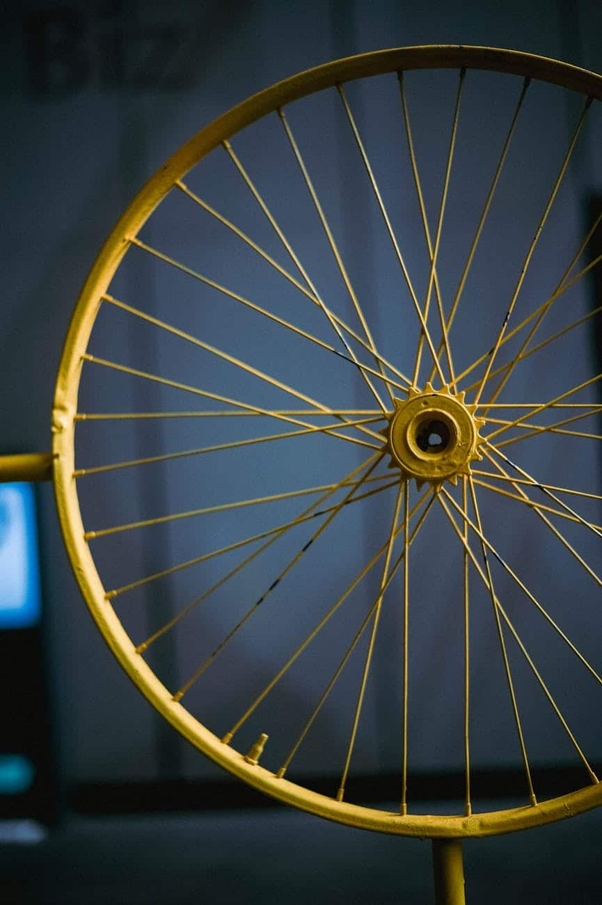 a close up shot of a yellow bicycle rim