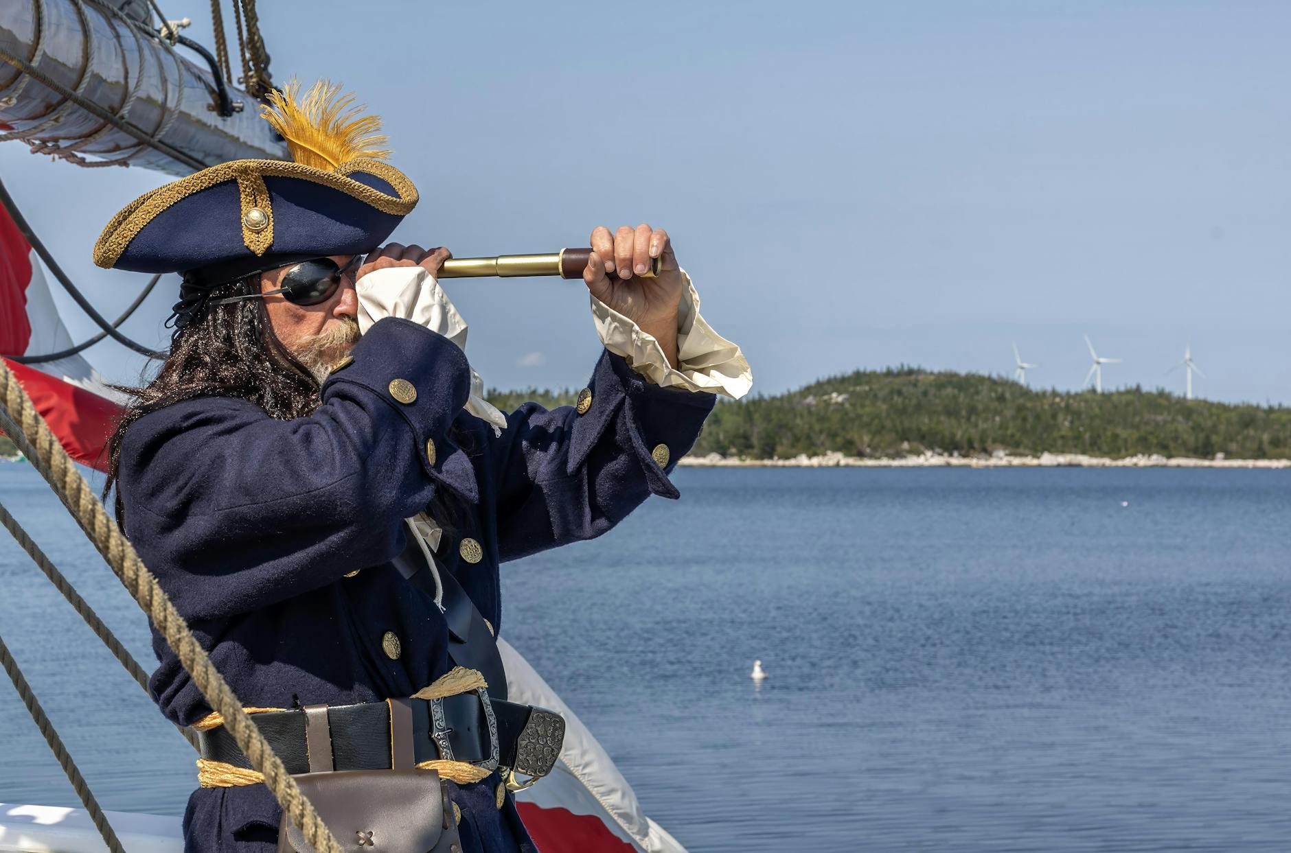pirate in costume with spyglass on ship