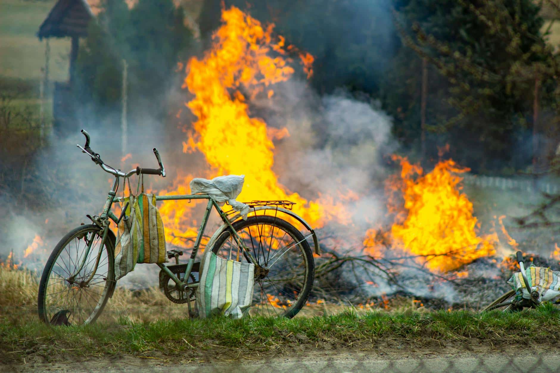 parked bicycle near burning grass