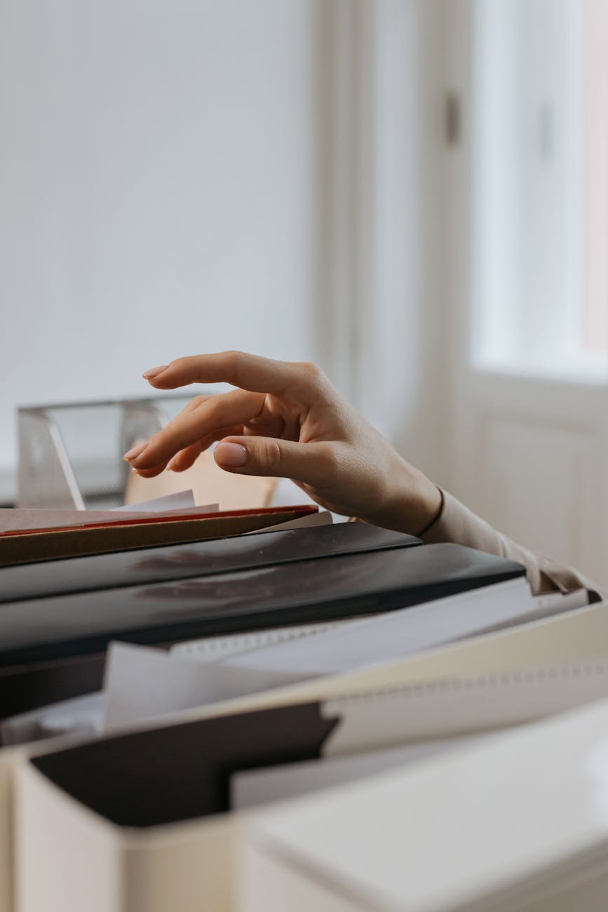 a person reaching out for a file