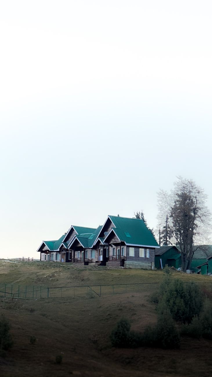 rustic green roof houses on a hillside