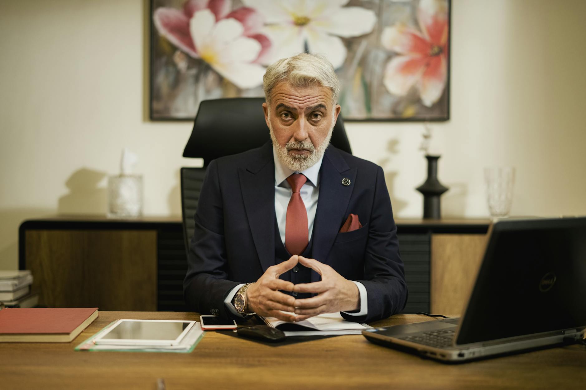 confident businessman at executive desk